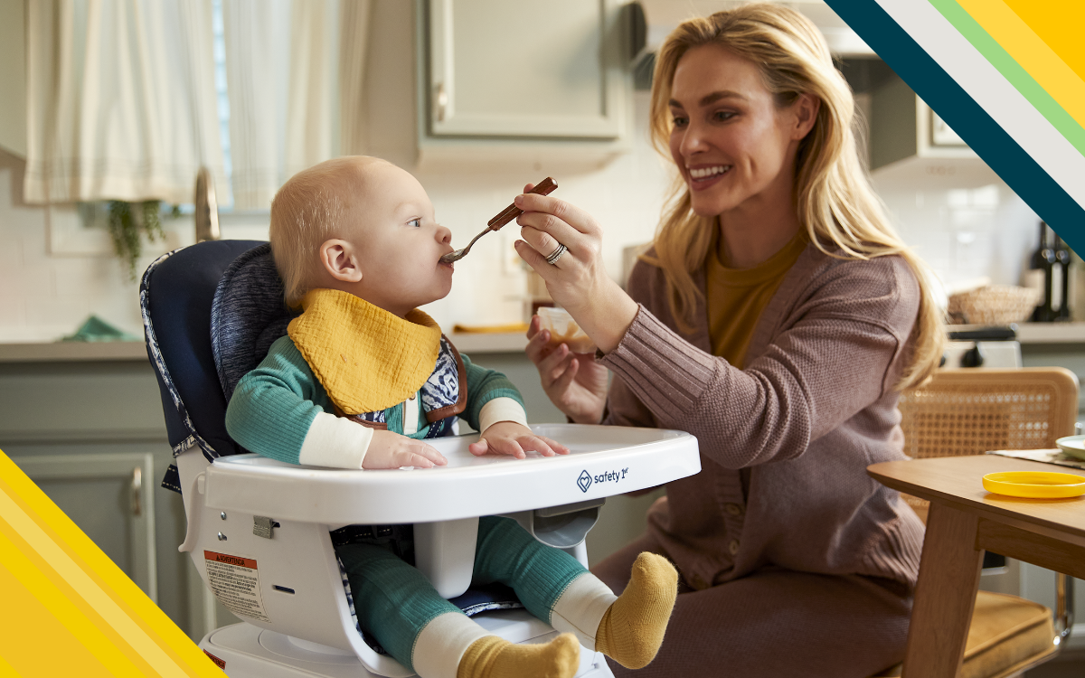 Mother feeding baby in high chair