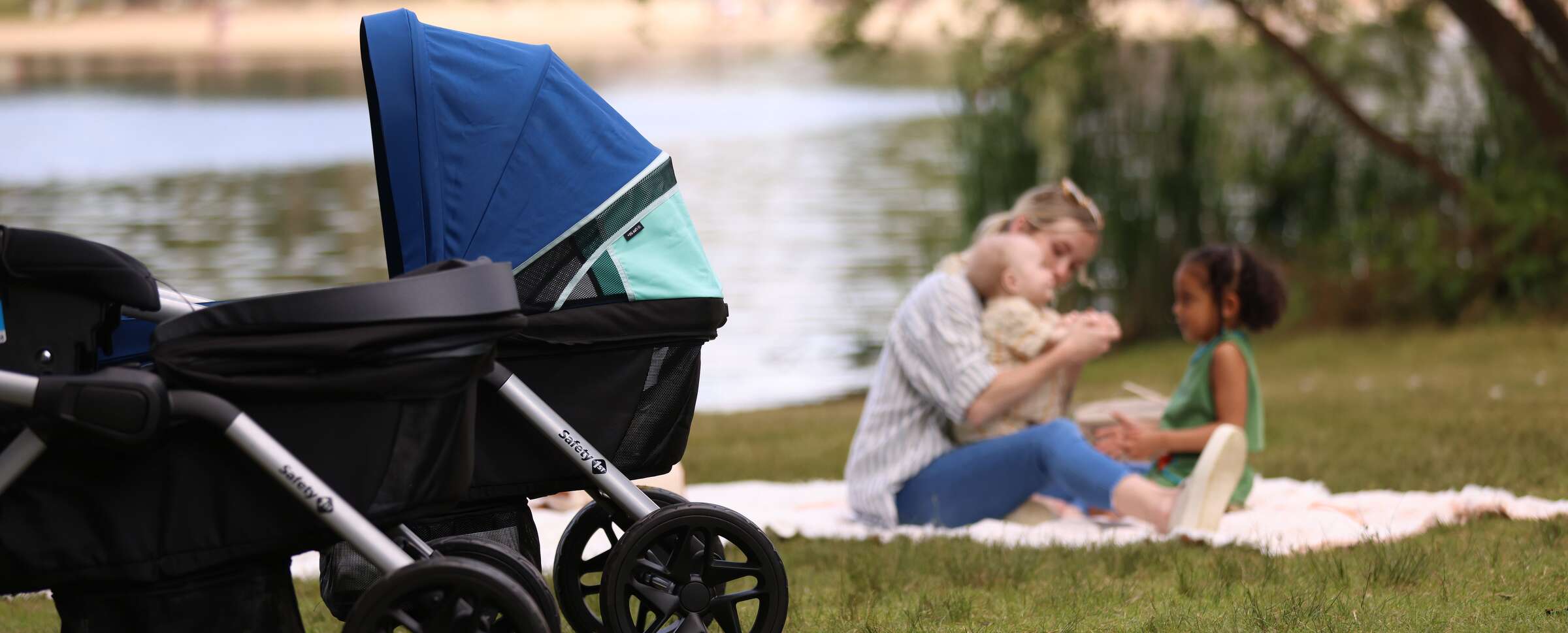 mom and baby on blanket in the background with wagon stroller in the foreground