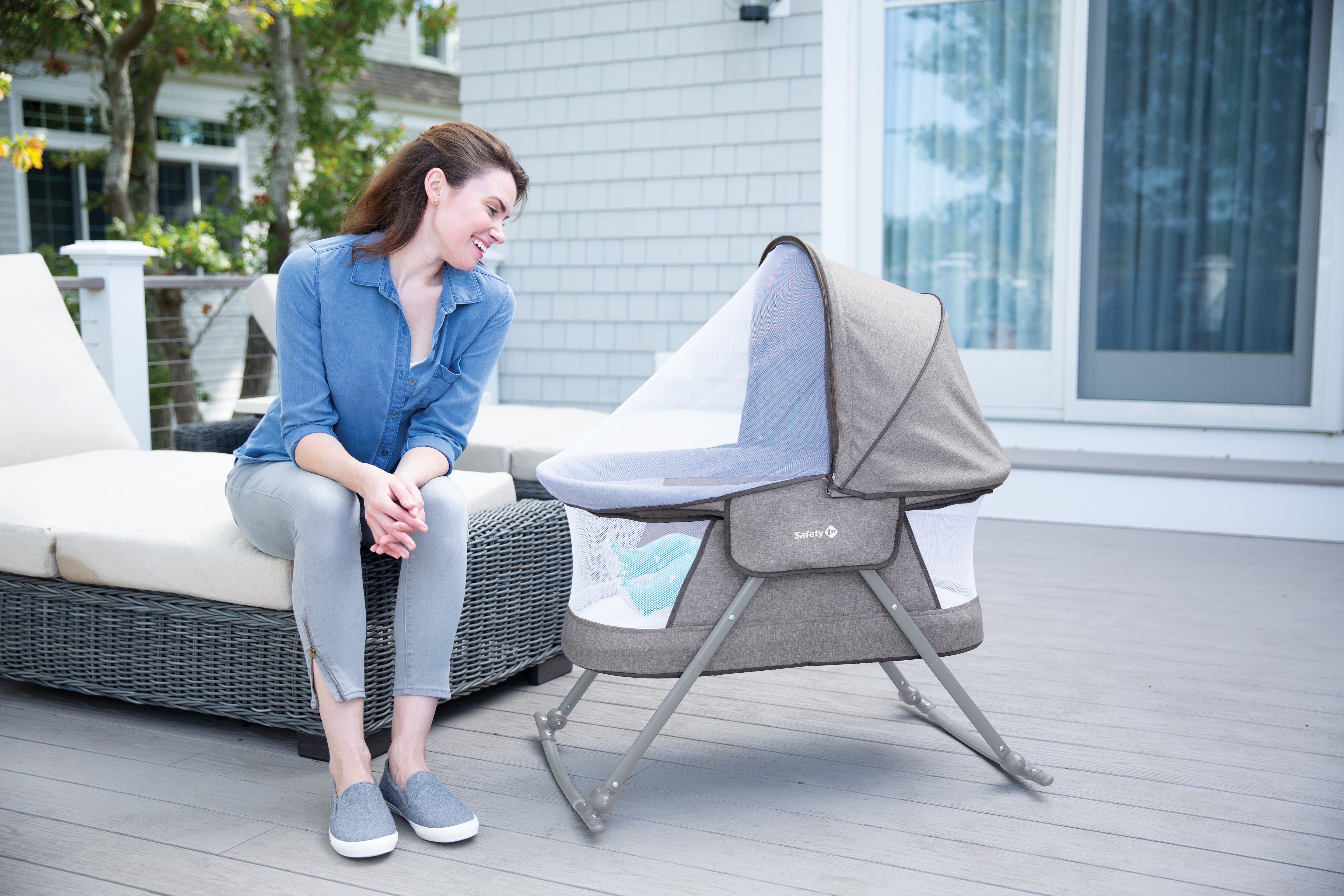 Mother smiling at baby in bassinet