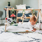 Tiny Love Luxe Developmental Gymini - baby doing tummy time on mat