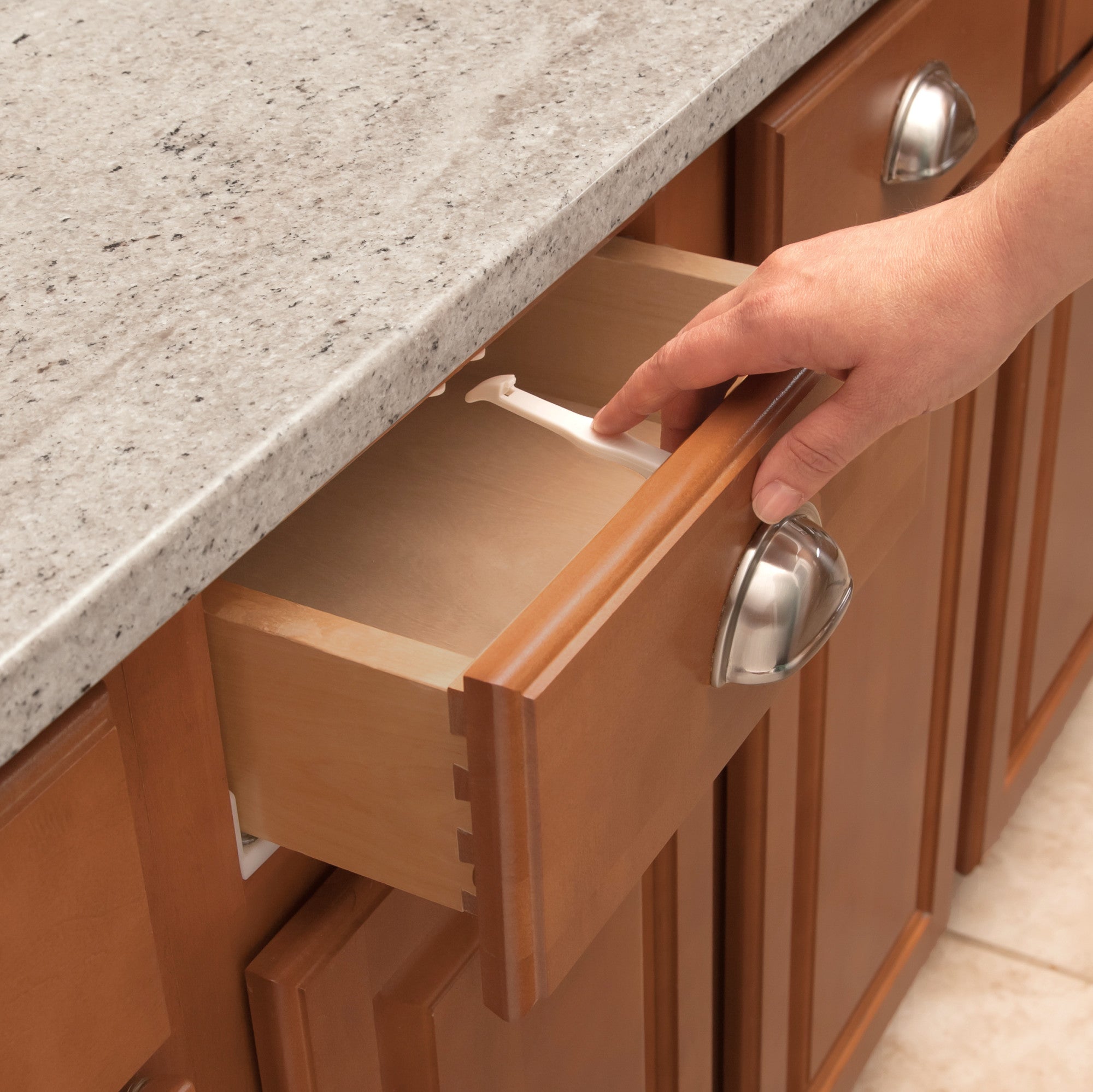 Parent showing how the lock is used on a cabinet drawer