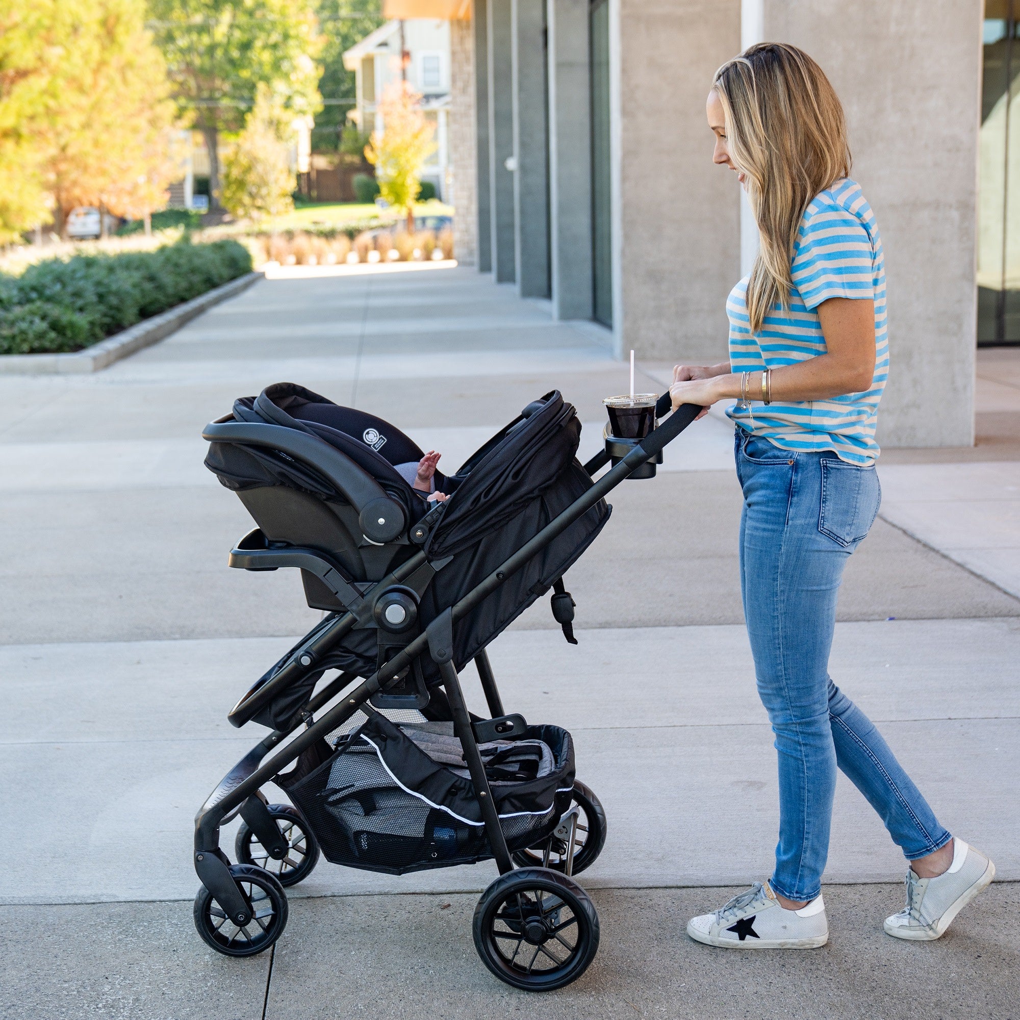 Mom pushing stroller outside