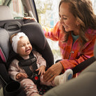 Disney Baby Easy Elite Slim All-In-One Convertible Car Seat - mother smiling at baby who smiles in rear-facing mode