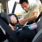 Grow and Go™ Sprint All-in-One Convertible Car Seat - father buckling daughter into rear-facing seat