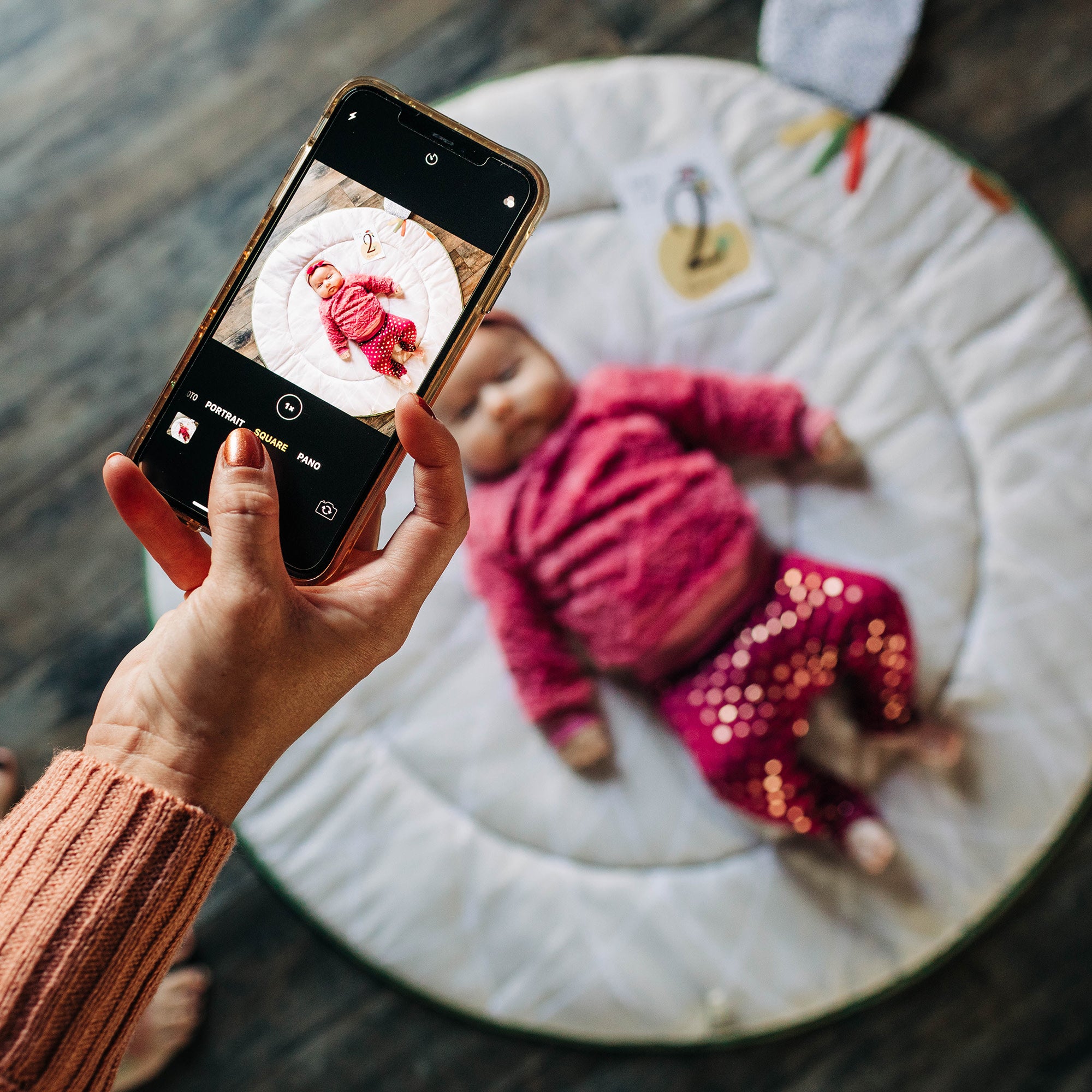 Tiny Love Luxe Developmental Gymini - woman taking pic of baby on mat