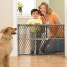 mother with her child looking over a gate at dog