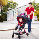 Father pushing toddler in Disney stroller