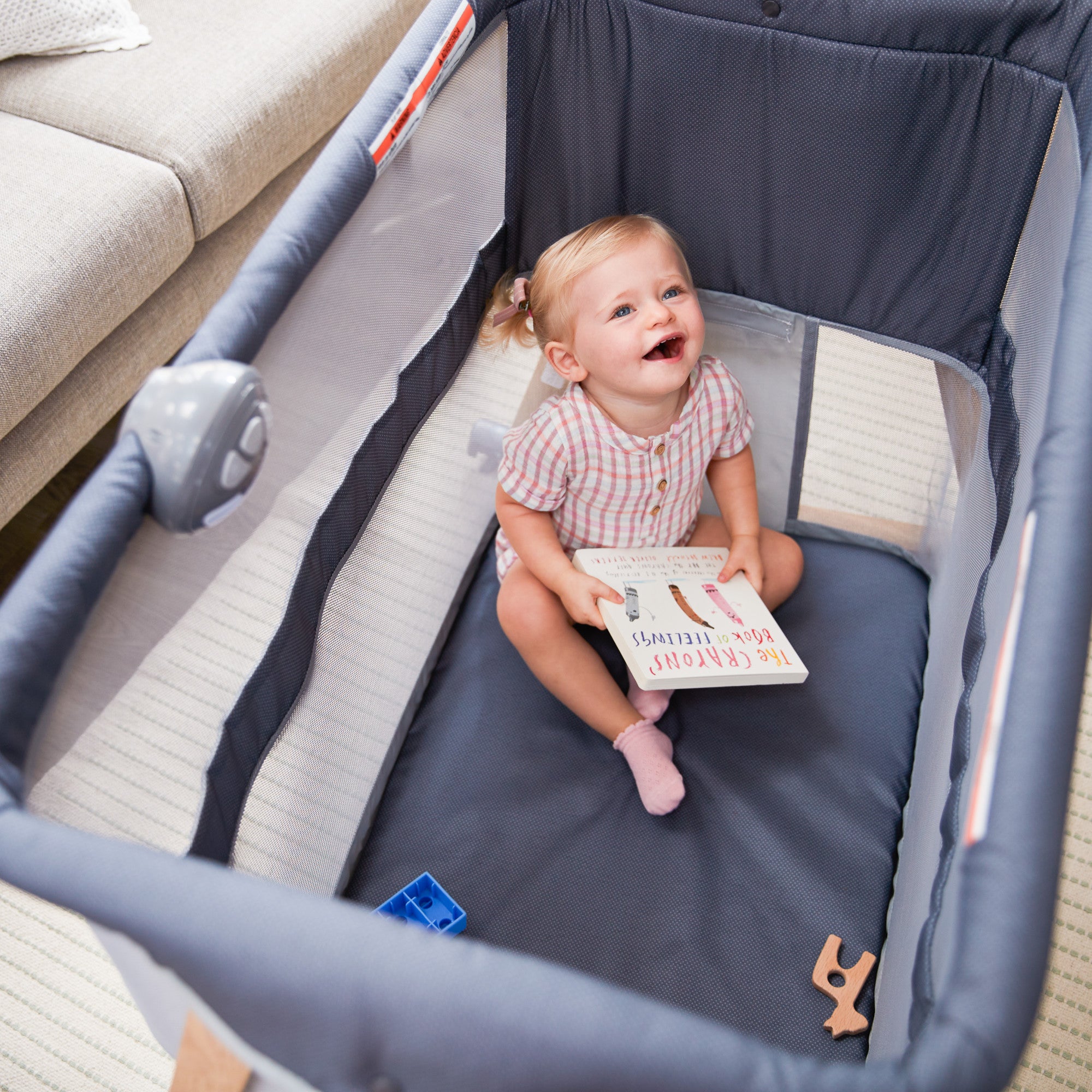 Rest-and-Romp Play Yard - toddler with book in play yard