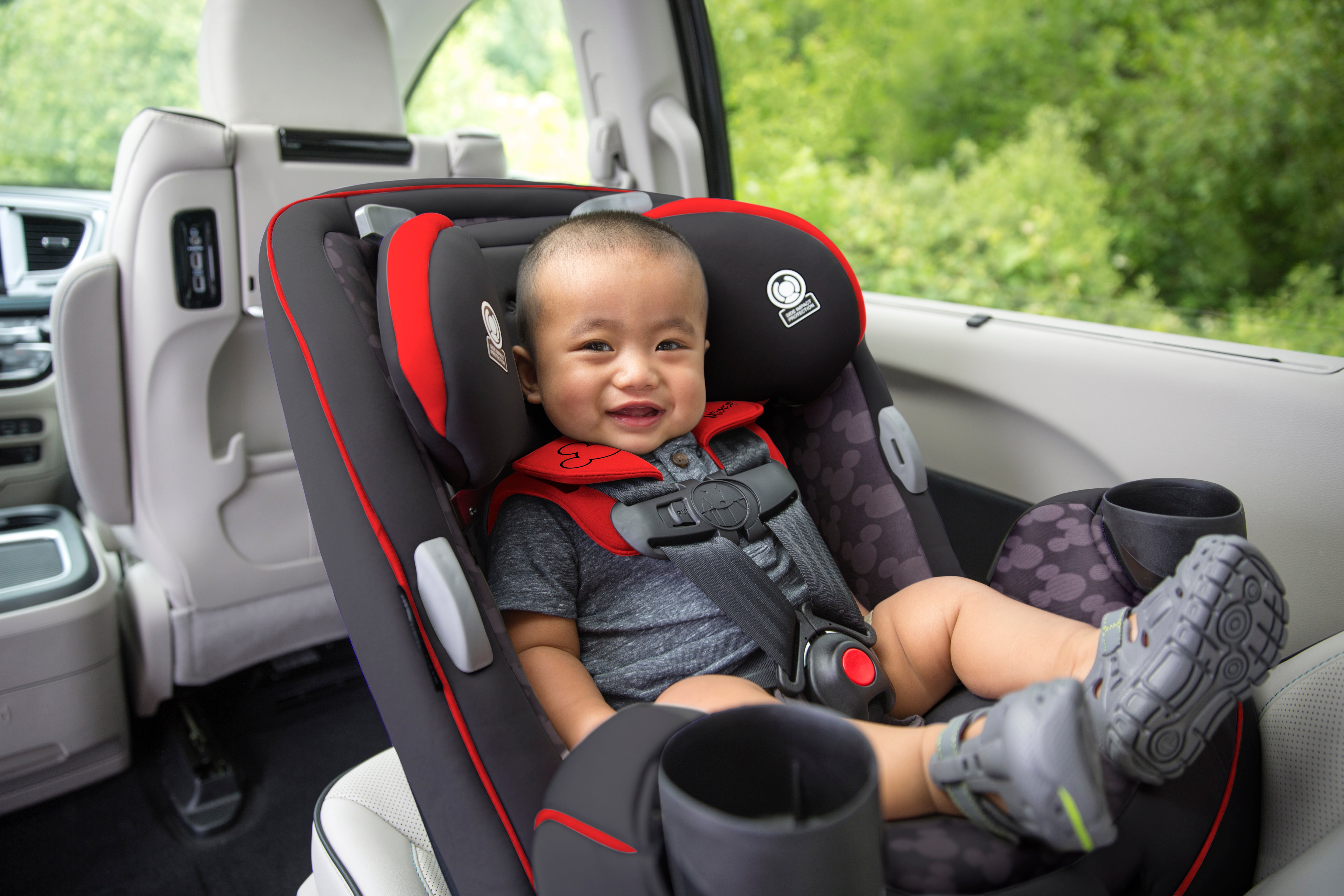 The Disney Baby Grow and Go™ All-in-One Convertible Car Seat - baby smiling in rear-facing car seat