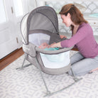 Mother doting on baby in bassinet