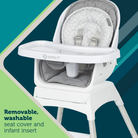 White high chair with gray seat cover on a green and blue striped background